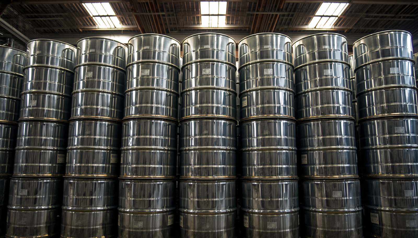 Stacks of metal barrels in a warehouse setting