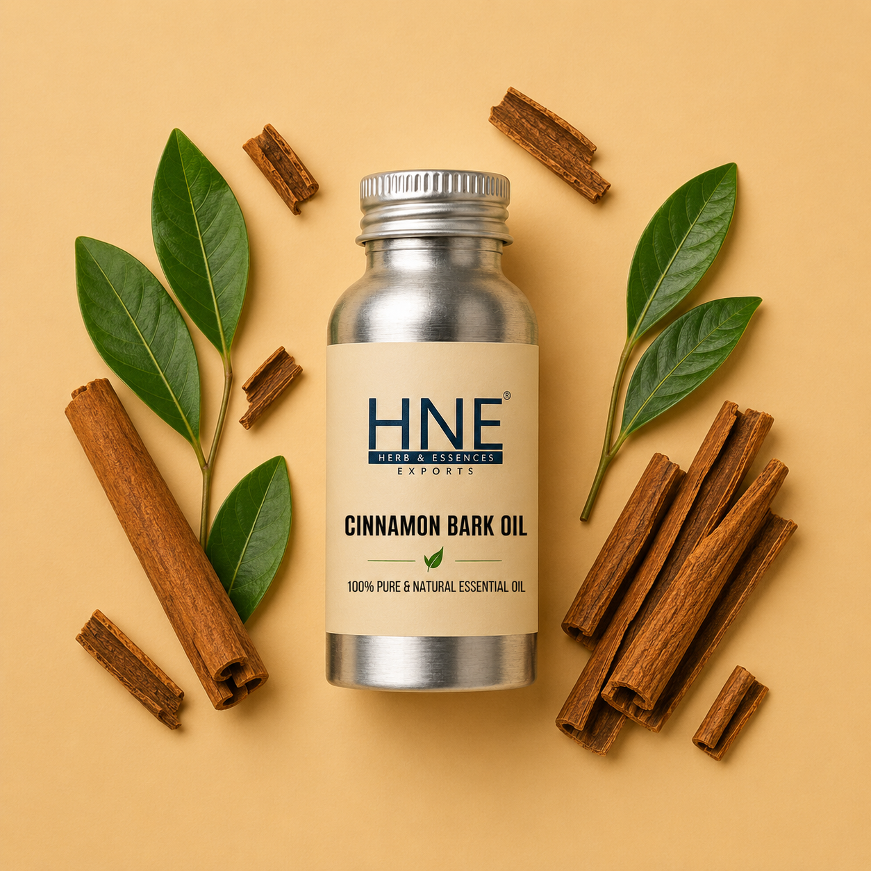 Bottle of HNE Cinnamon Bark Essential Oil with cinnamon sticks and leaves on a beige background