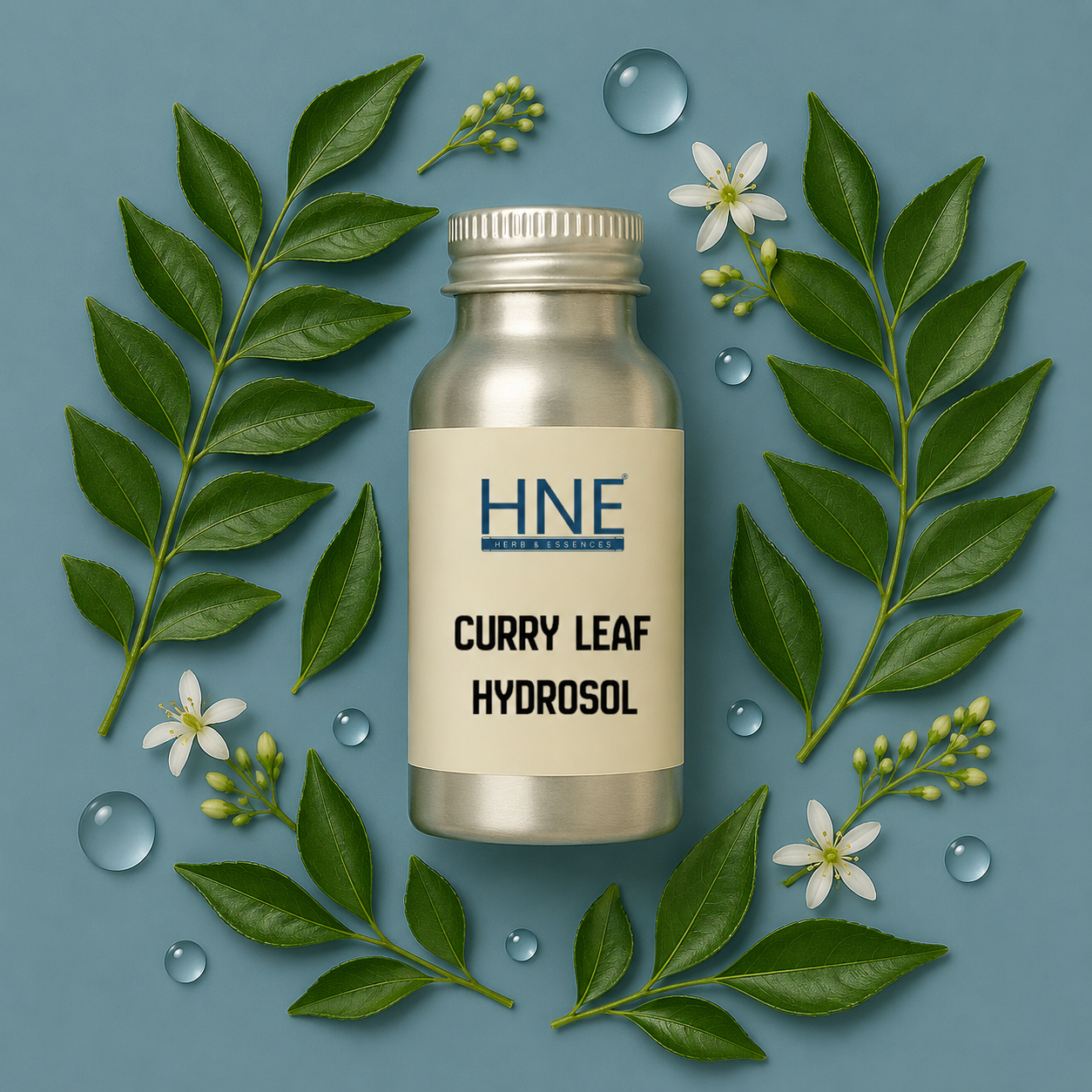 Bottle of HNE Curry Leaf Hydrosol surrounded by curry leaves and flowers on a blue background