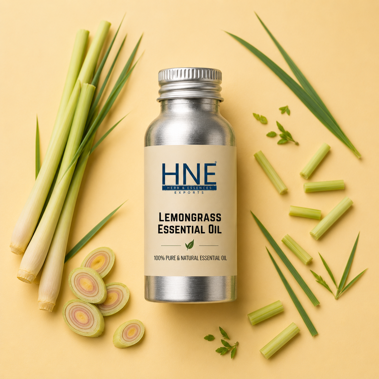 Bottle of HNE Lemongrass Essential Oil with lemongrass stalks and leaves on a yellow background
