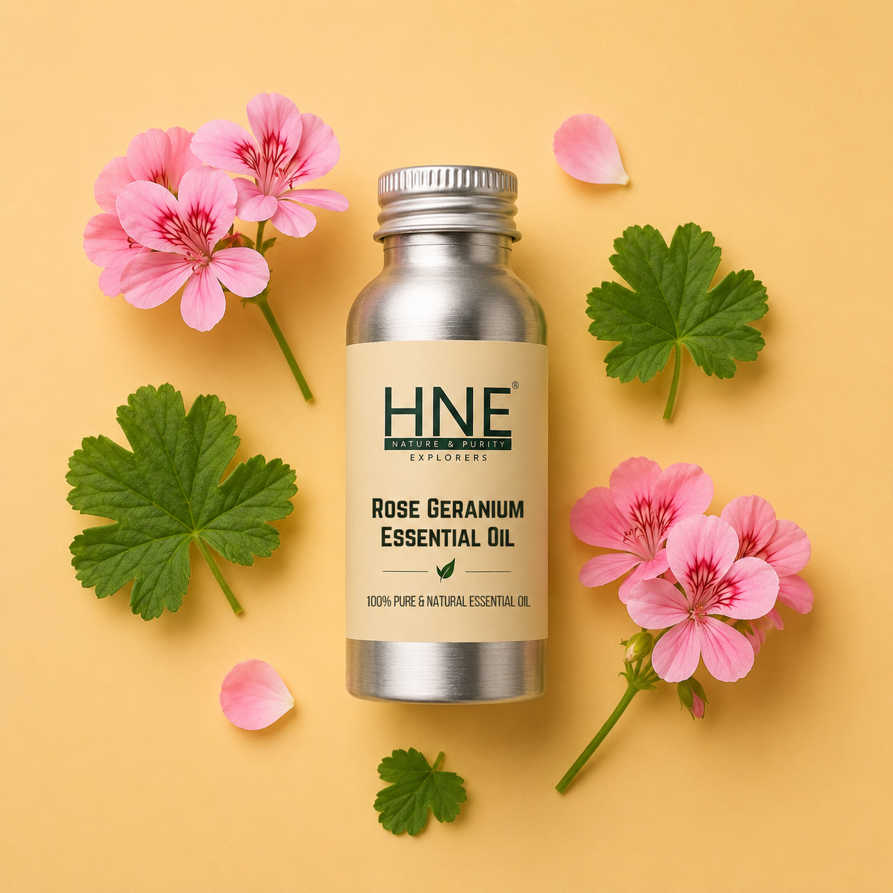 HNE Rose Geranium Essential Oil bottle with pink flowers and green leaves on a yellow background