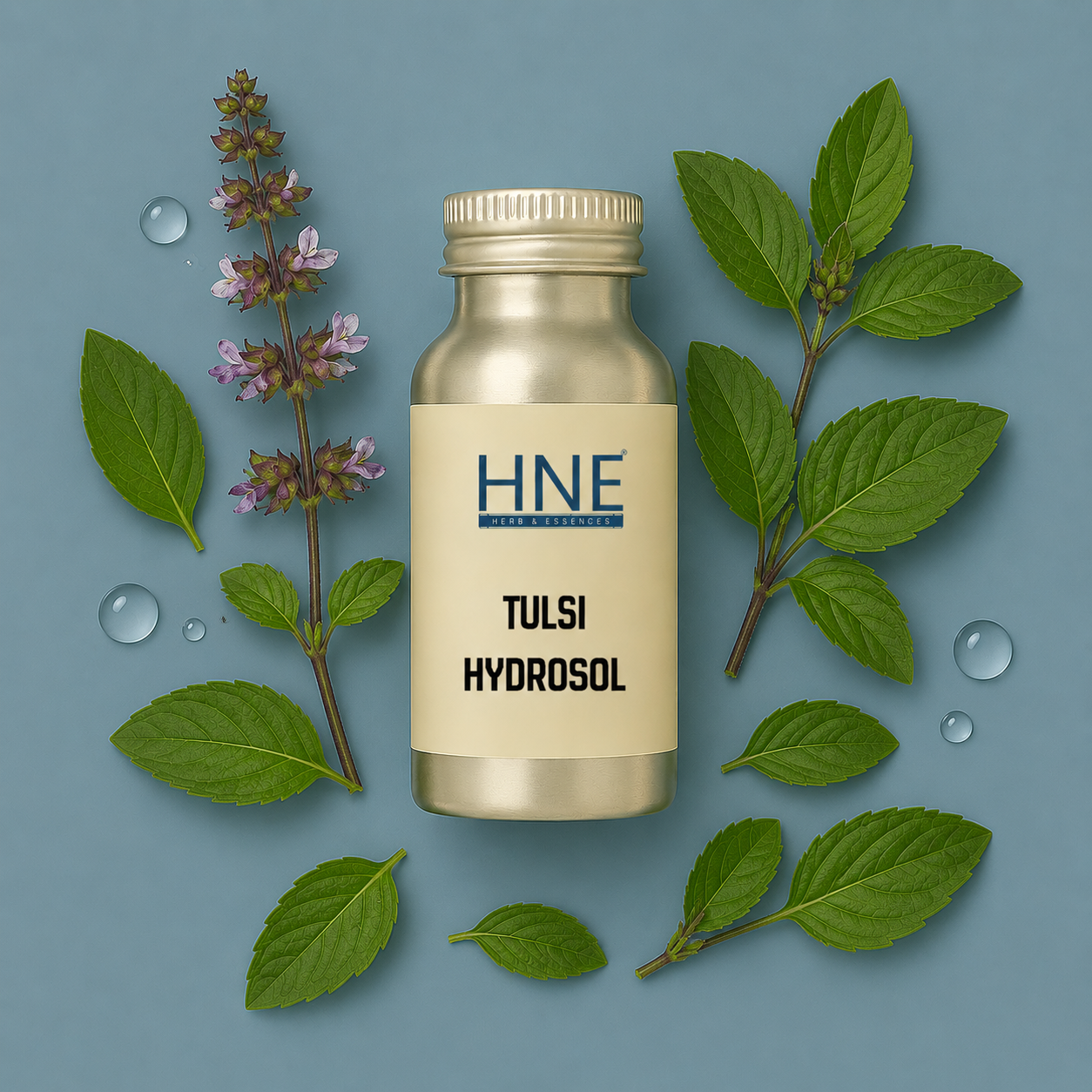 Bottle of HNE Tulsi Hydrosol with tulsi leaves and flowers on a blue background