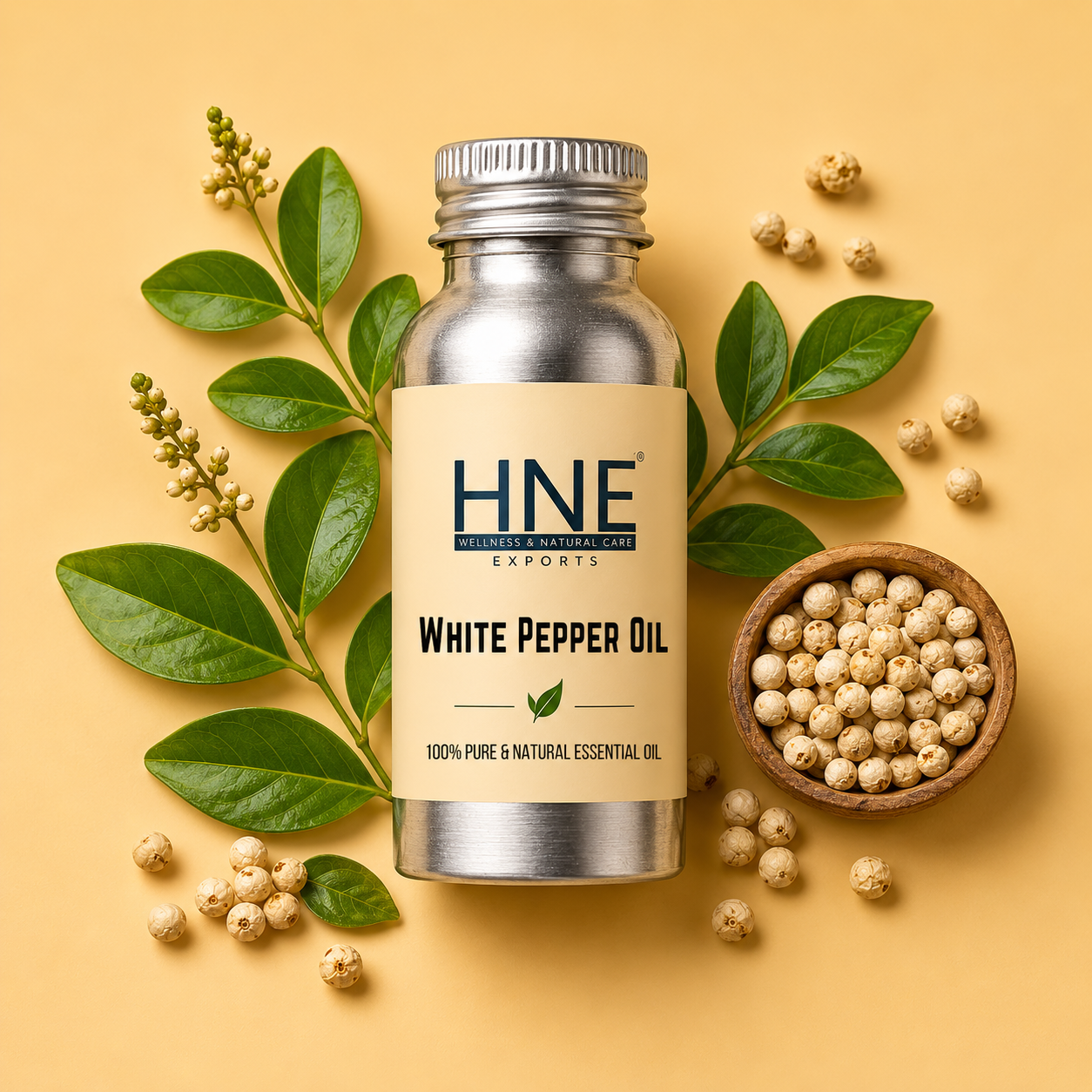 Bottle of HNE White Pepper Oil with white peppercorns and leaves on a yellow background