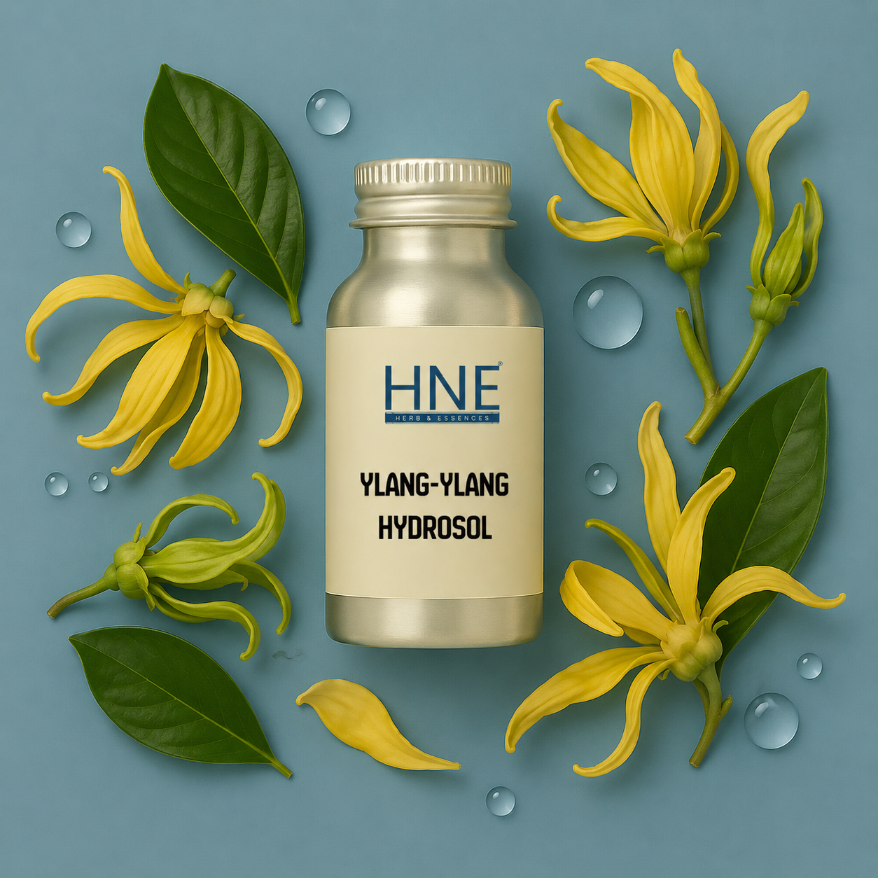 Ylang-ylang hydrosol bottle with flowers and leaves on a blue background